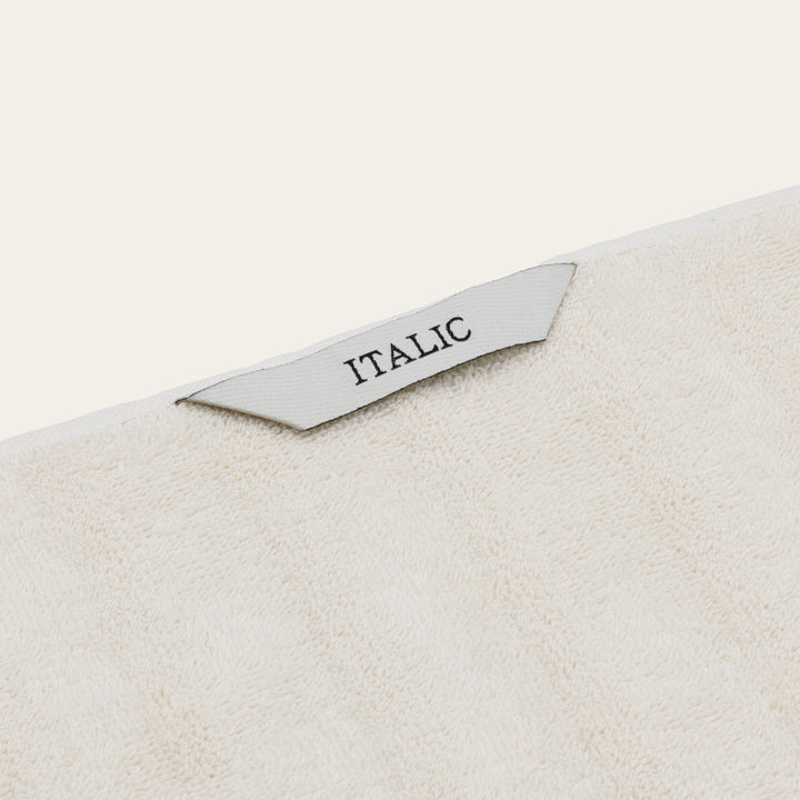 White cotton towel corner label reading “ITALIC”