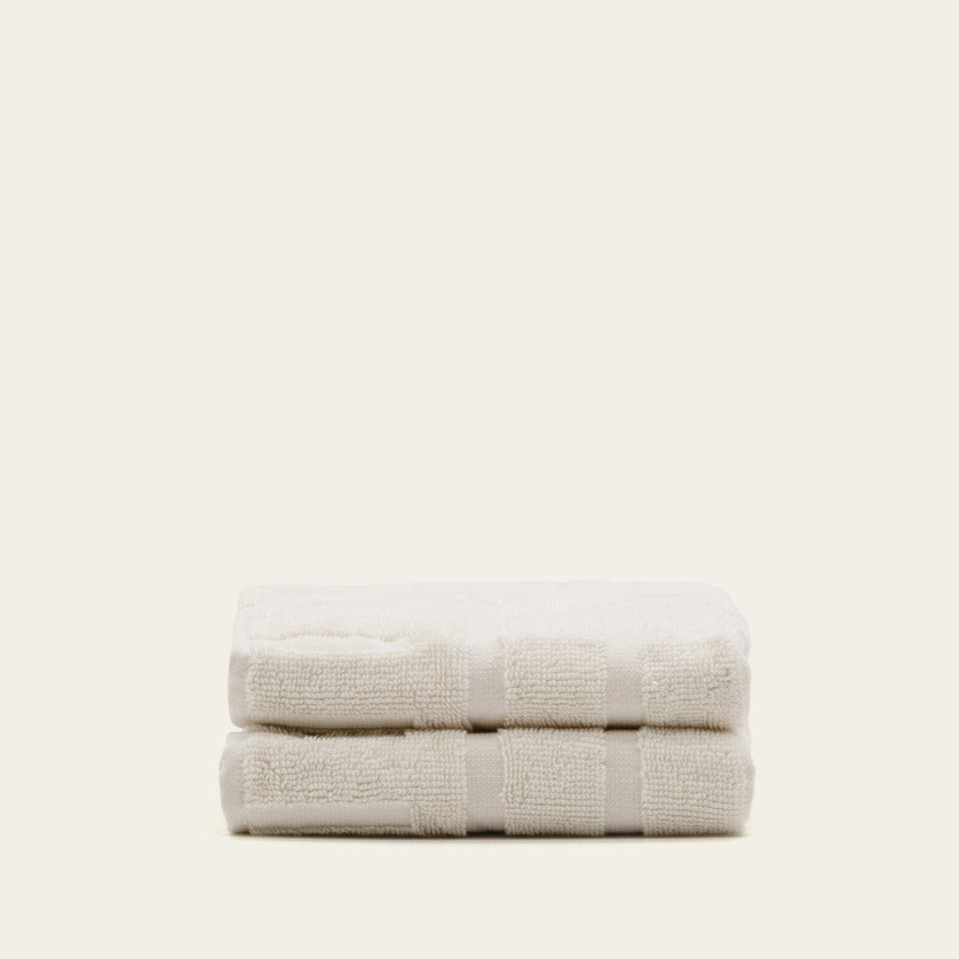 Ecru cotton towel stack, folded with double stripe border