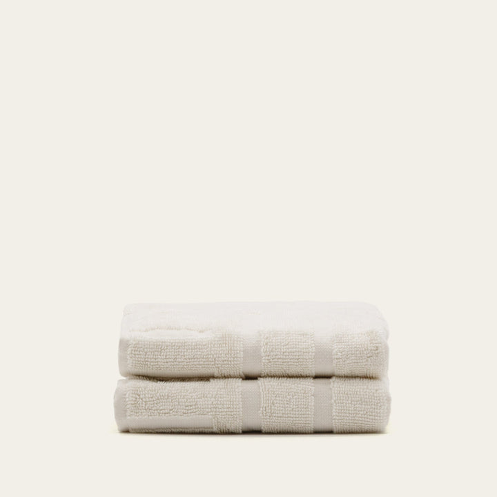 Ecru cotton towel stack, folded with double stripe border