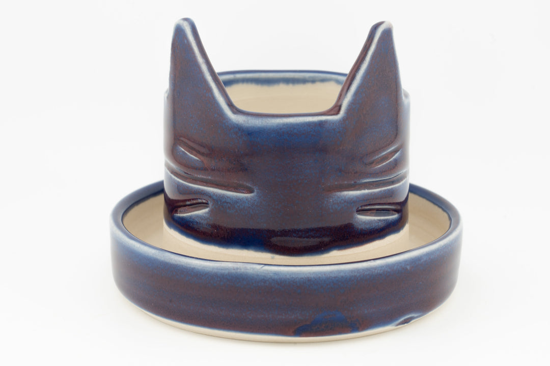 Dark blue cat-shaped planter with matching saucer, glossy glaze