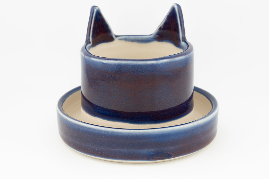 Navy-blue cat planter cup with round saucer base, curved cat-ear profile