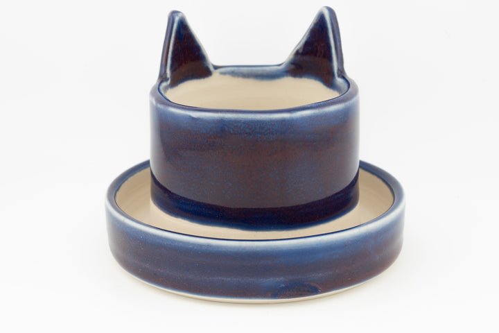 Navy-blue cat planter cup with round saucer base, curved cat-ear profile