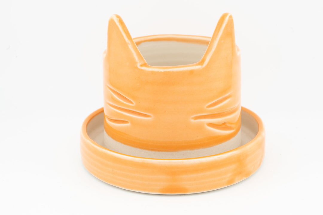 Light orange cat planter with matching saucer, smooth glossy glazed ceramic
