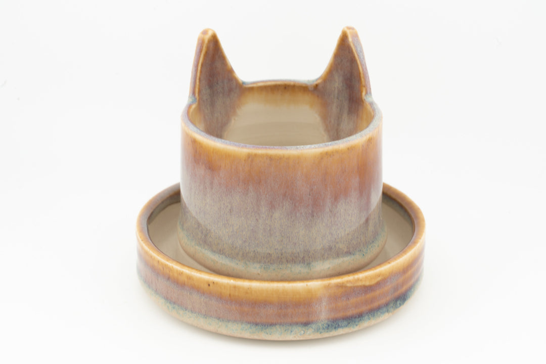 Light blue-gray cat planter cup with round saucer base, glazed ceramic
