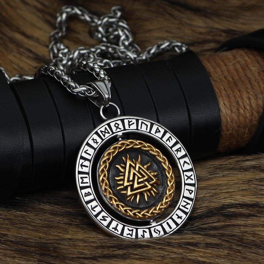 Stainless steel rune pendant necklace, close-up round medallion with gold braid and dark center.