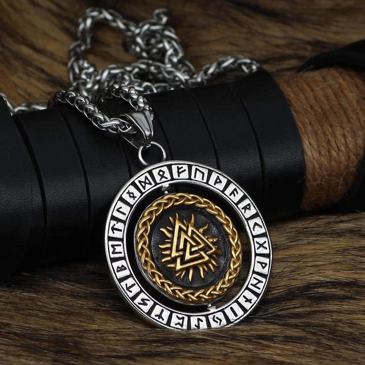 Stainless steel rune pendant necklace, close-up round medallion with gold braid and dark center.