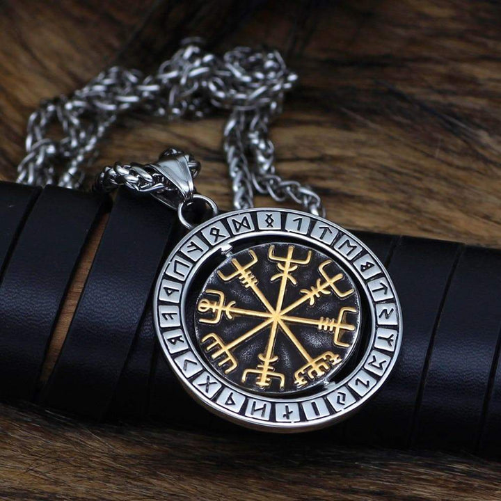 Stainless steel rune pendant necklace, round medallion with gold symbol lines on dark center.