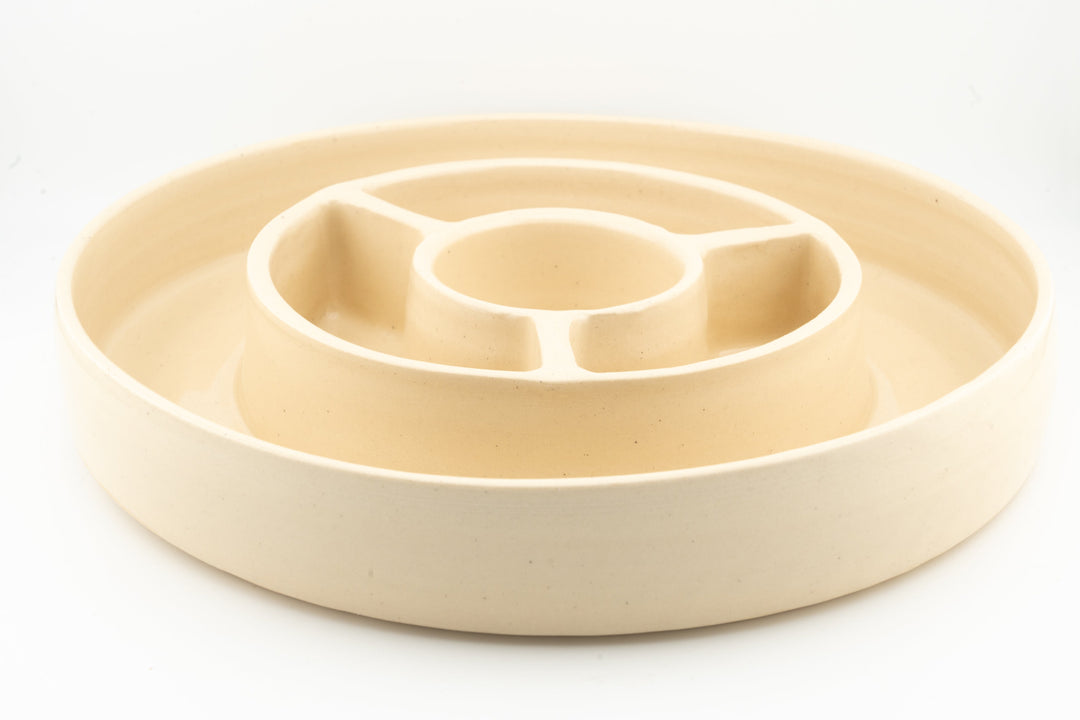 Ceramic cheese plate with ring-shaped divider and center serving cup, beige glaze.
