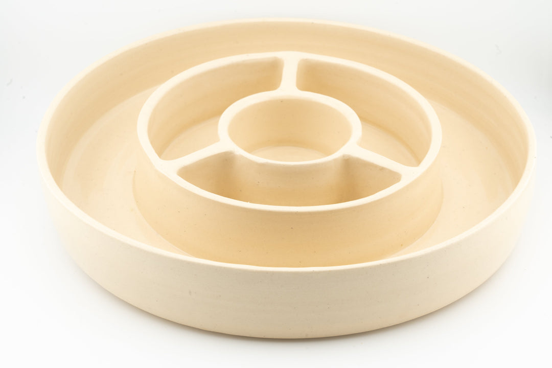 Ceramic cheese plate with circular divider and central serving cup, beige glaze.