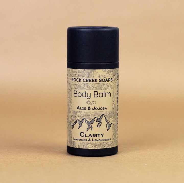 Solid body balm stick, Clarity label, aloe & jojoba, black container