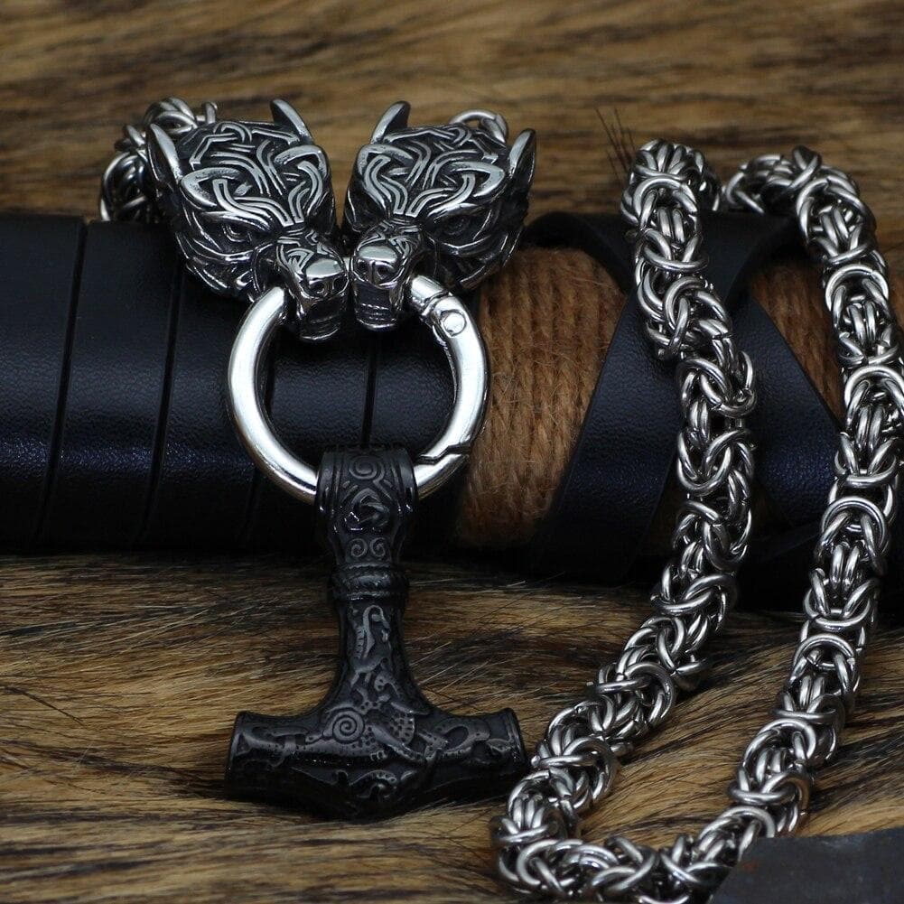 Close-up stainless steel chain necklace with wolf-head clasp and hammer pendant