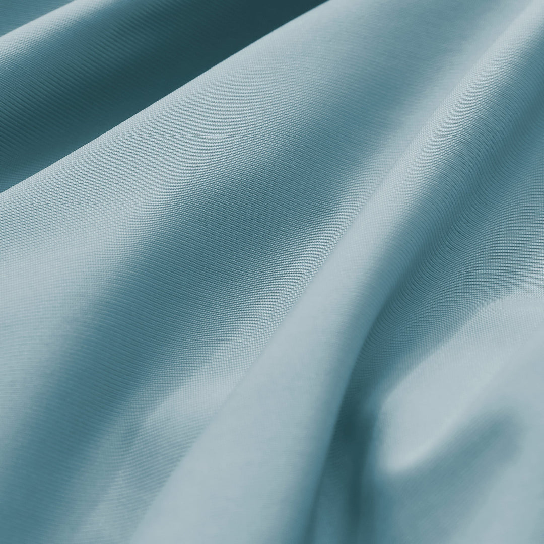 Teal-blue pillowcase fabric with fine woven texture and subtle sheen