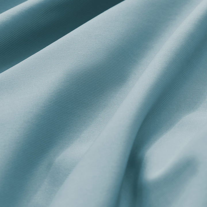 Teal-blue pillowcase fabric with fine woven texture and subtle sheen