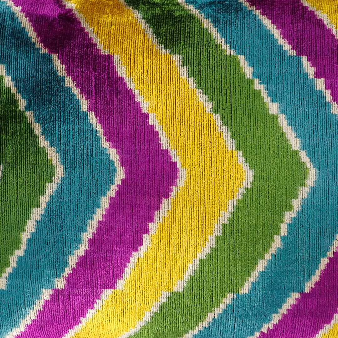 Close-up velvet ikat chevron stripes in green, purple, yellow, and blue