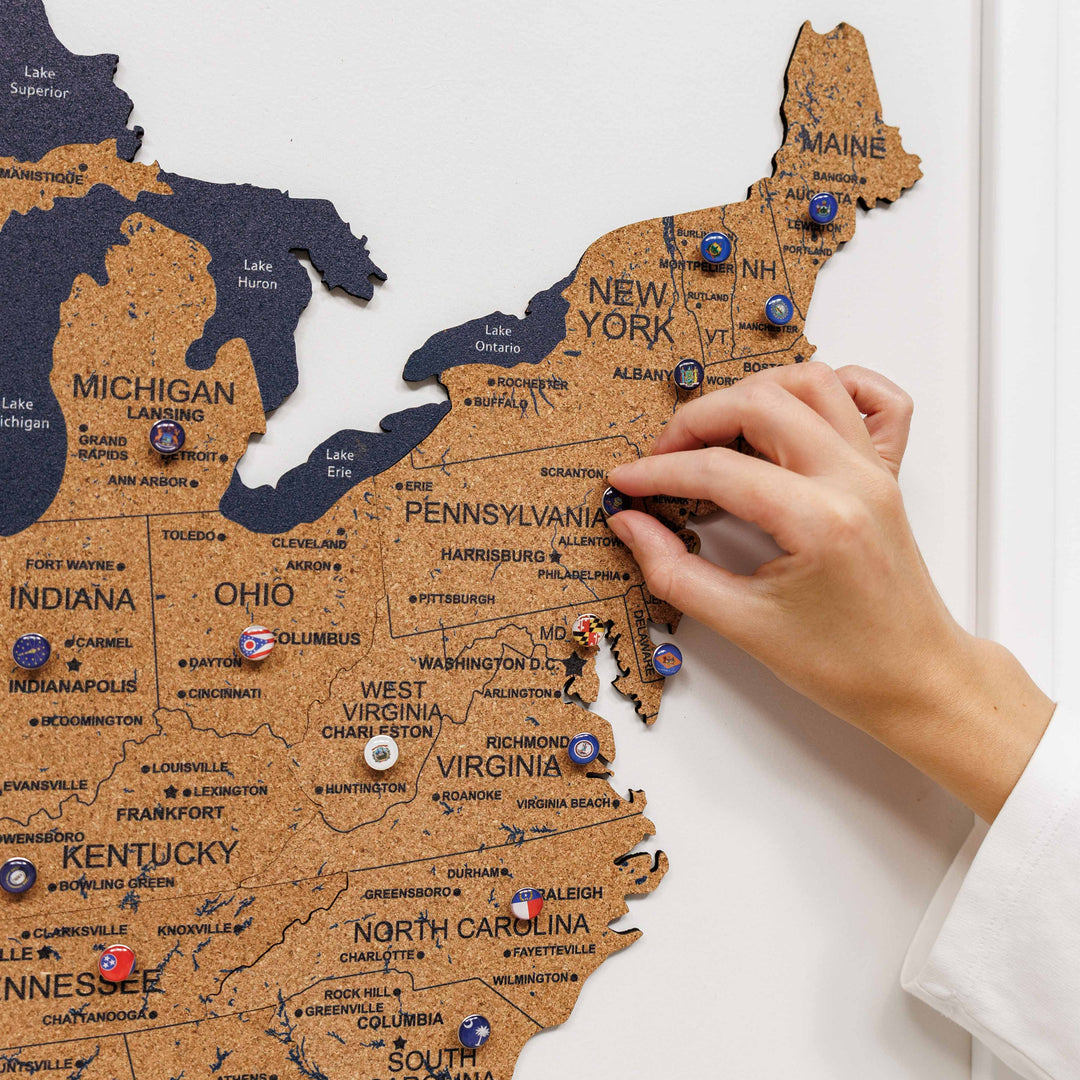 Close-up of New York and Pennsylvania sections on a cork USA map with pins