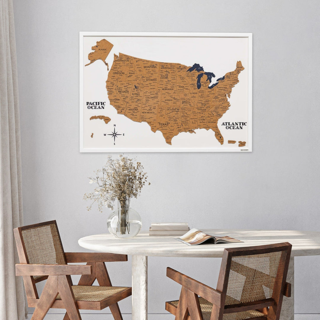 White-framed cork USA map board, wall-hung above table