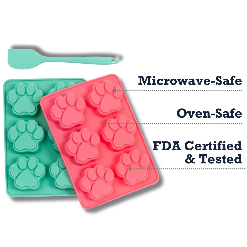 Green and pink silicone paw-print baking trays with turquoise spatula