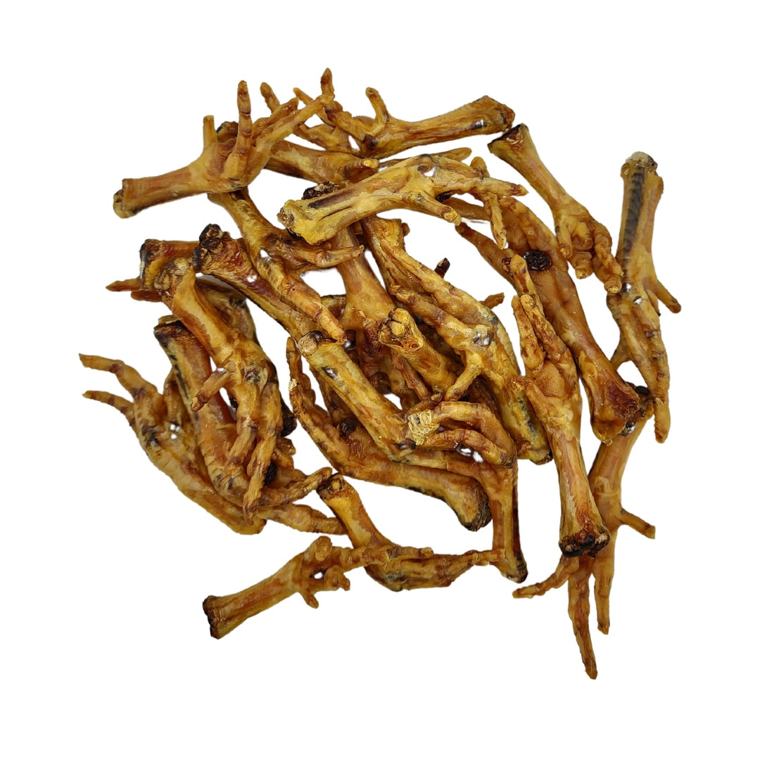 Pile of dried chicken feet dog treats, brown and tan