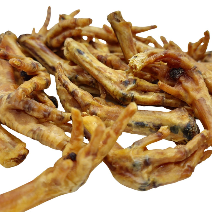 Close-up of chewy chicken feet dog treats, golden brown with darker spots