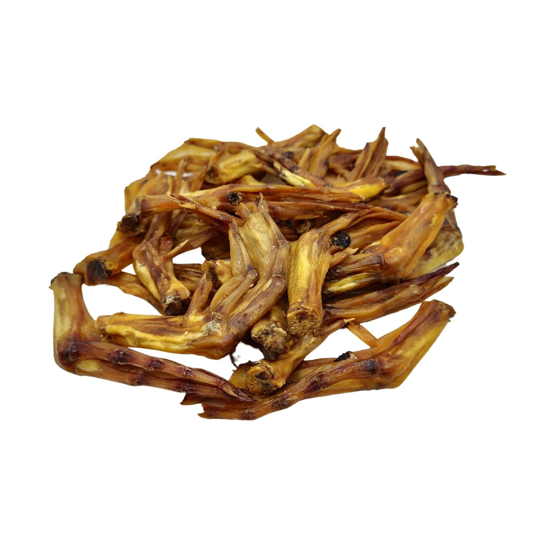 Duck foot dog treats, natural dried chew pieces in warm brown