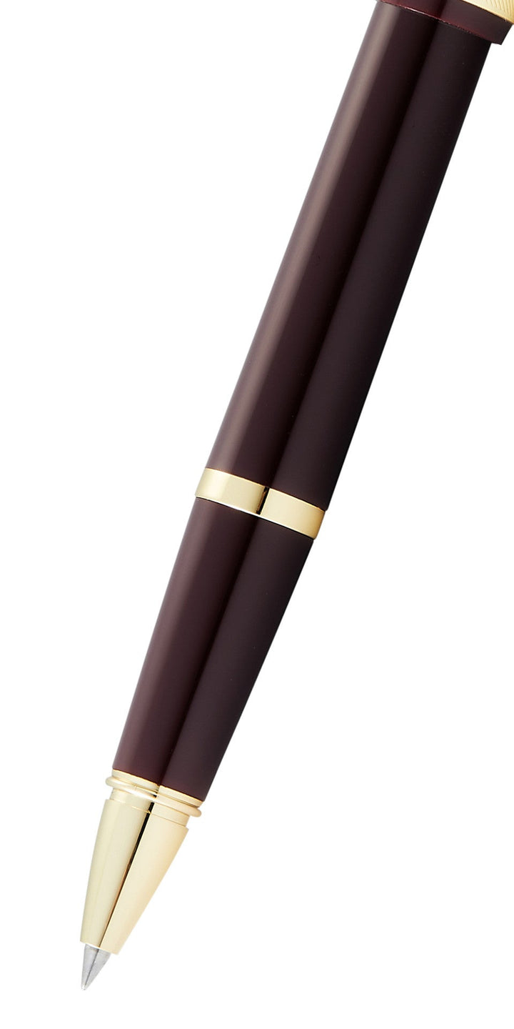 Close-up of burgundy resin rollerball pen tip with gold-tone barrel accents