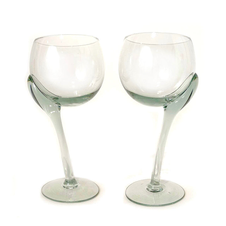 Two crooked-stem wine glasses with green-tinted lower bowls and round bases.