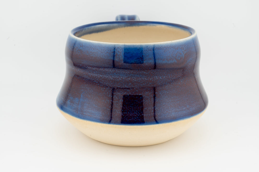 Ceramic wide mug with deep blue glaze and wide rim, speckled textured surface