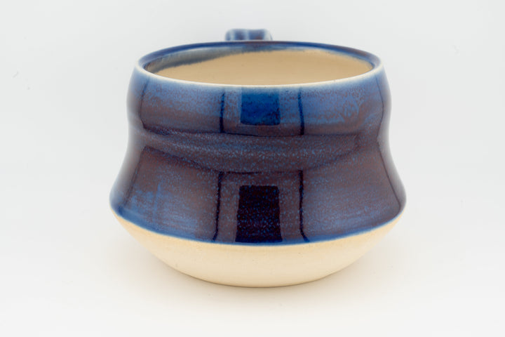 Ceramic wide mug with deep blue glaze and wide rim, speckled textured surface