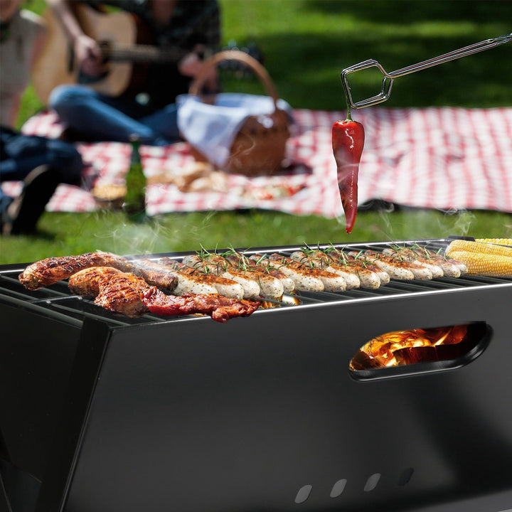 Charcoal grill cooking tray with assorted meat on the wire grate, black
