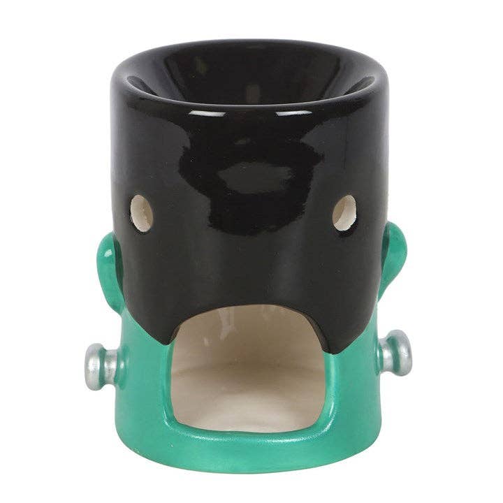 Halloween monster oil burner, teal ceramic base with black top and side handle knobs.