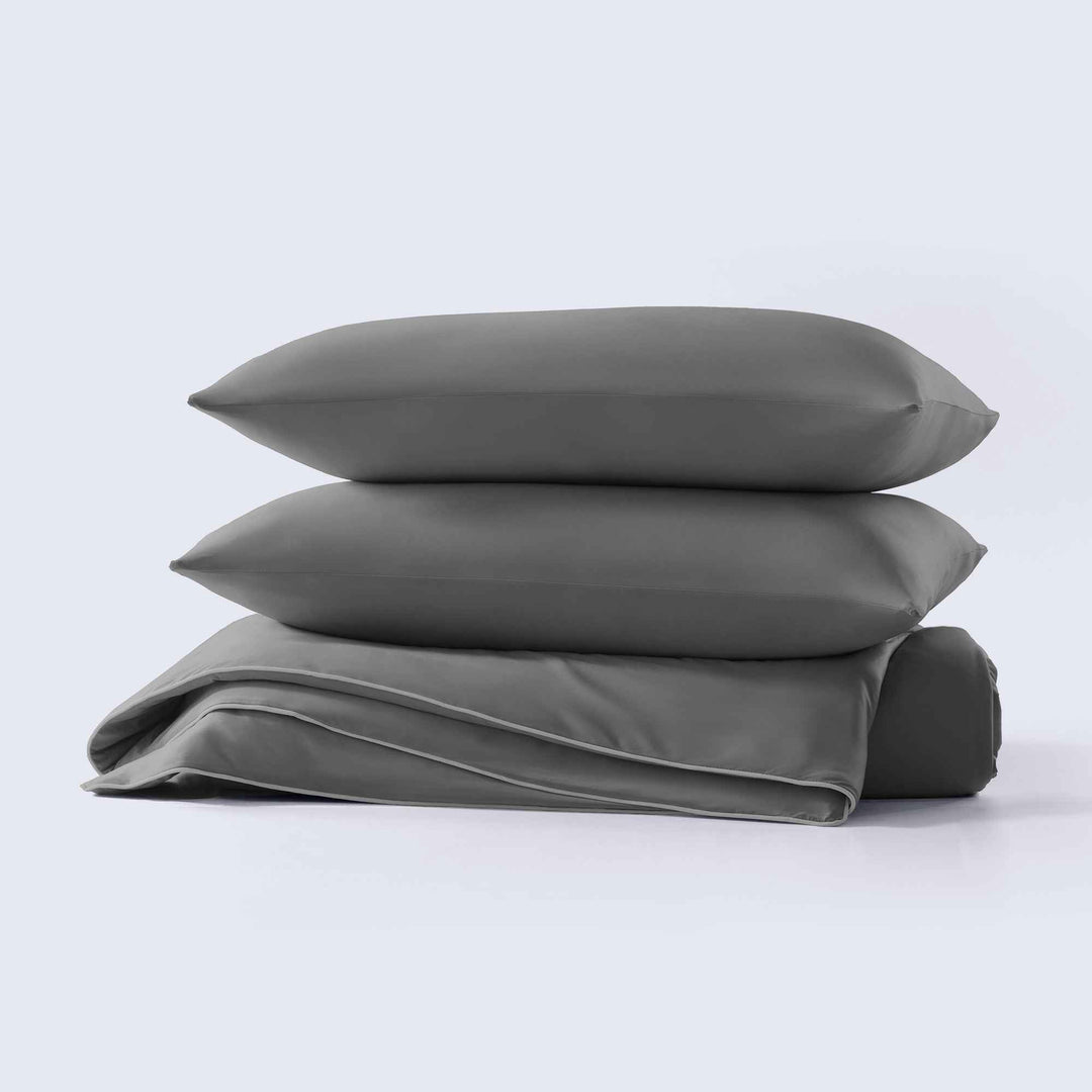 Dark gray cooling comforter set, stacked shams and folded comforter