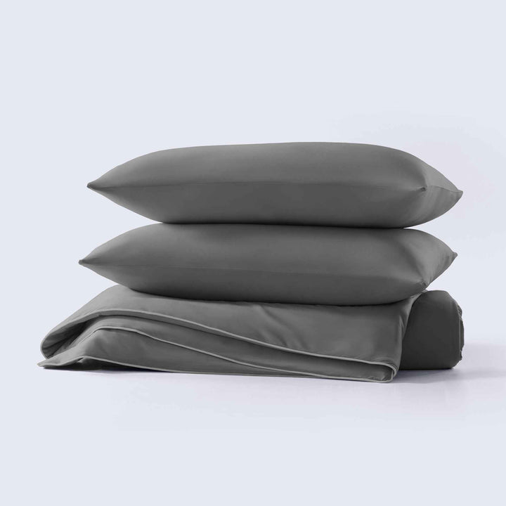 Dark gray cooling comforter set, stacked shams and folded comforter