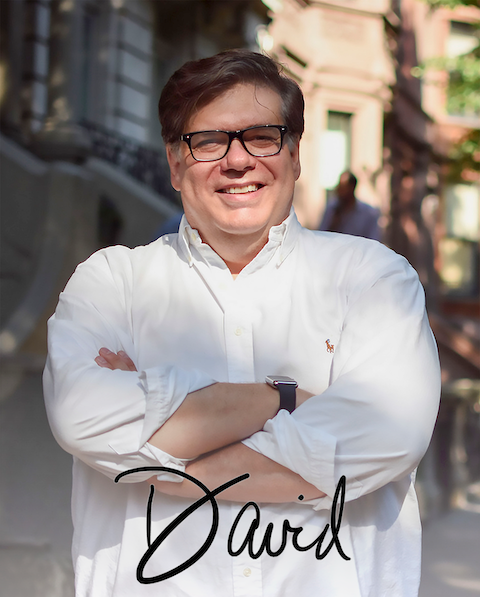 Chef in white coat, black glasses, smiling, arms crossed; "David" script
