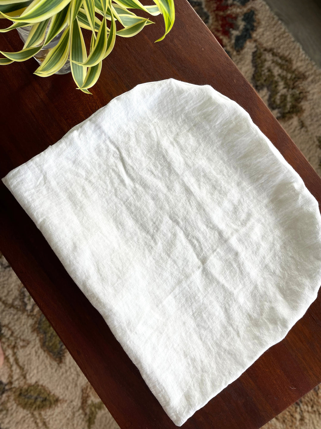 Off-white washed linen lounger slip cover, folded rectangular cushion