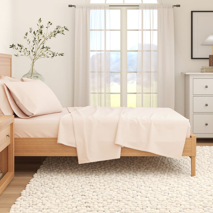 Off-white cotton flannel sheet set on bed with pillowcases