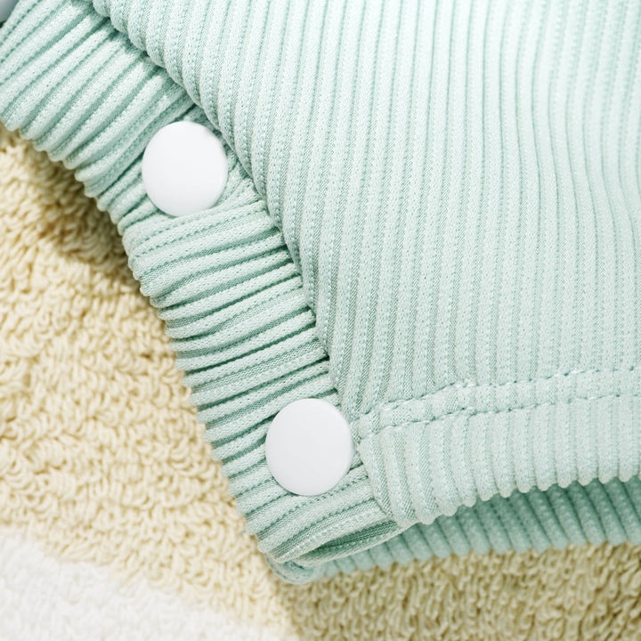 Mint ribbed swim romper with snap buttons at front placket and leg opening