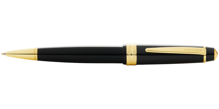 Black resin ballpoint pen with gold tip and 'CROSS' logo on barrel