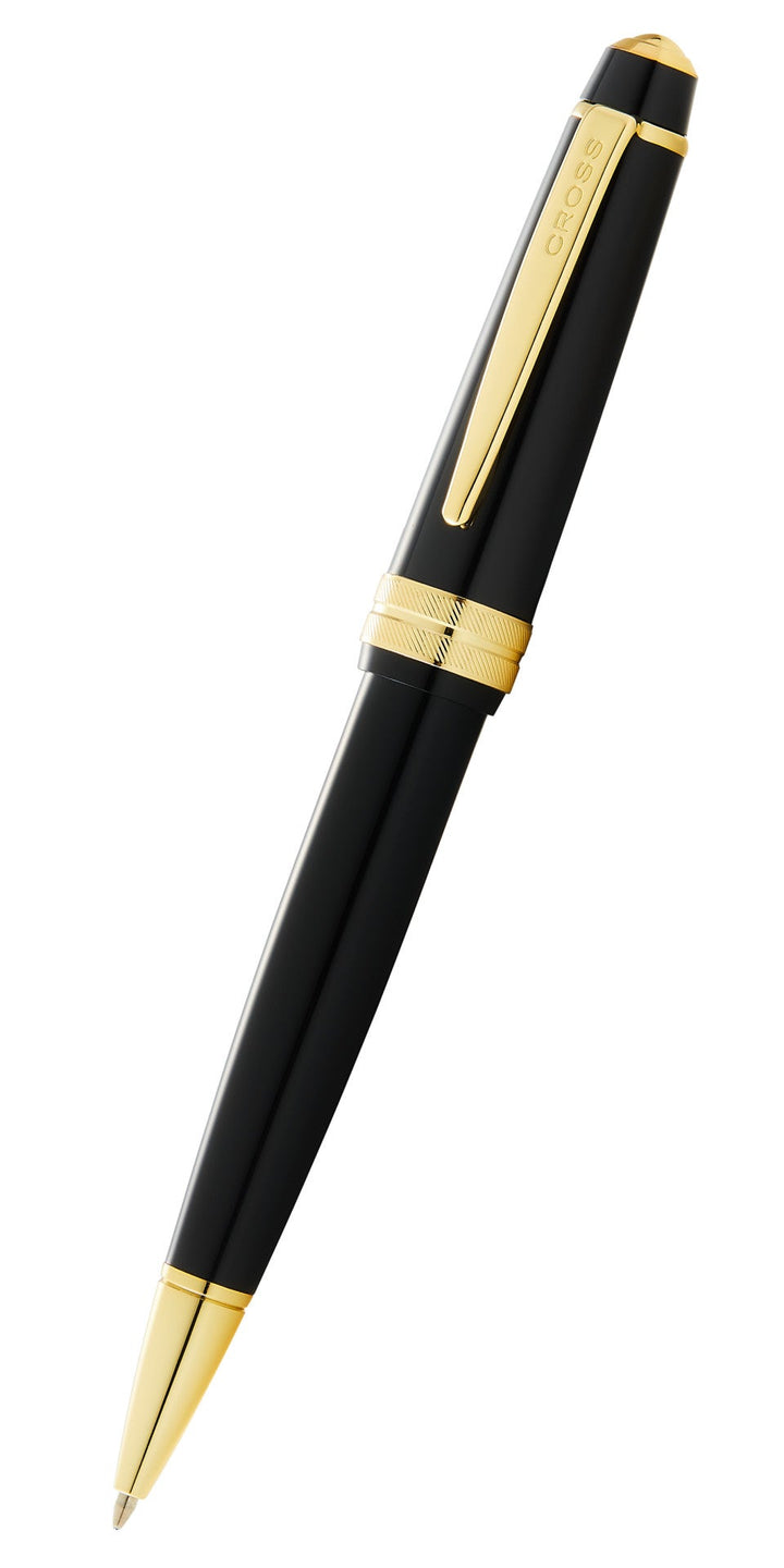 Polished black resin ballpoint pen with gold tone accents and pointed tip