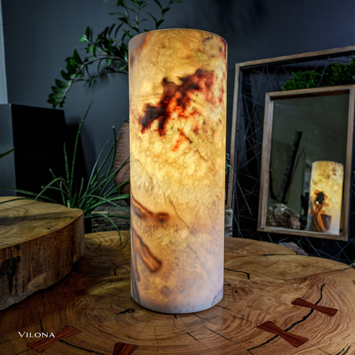 Onyx table lamp cylindrical shade with warm amber glow through dark veining