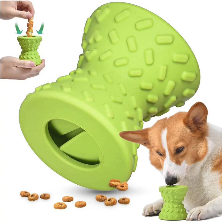 Green hollow rubber chew toy with textured prongs; dog near toy and kibble
