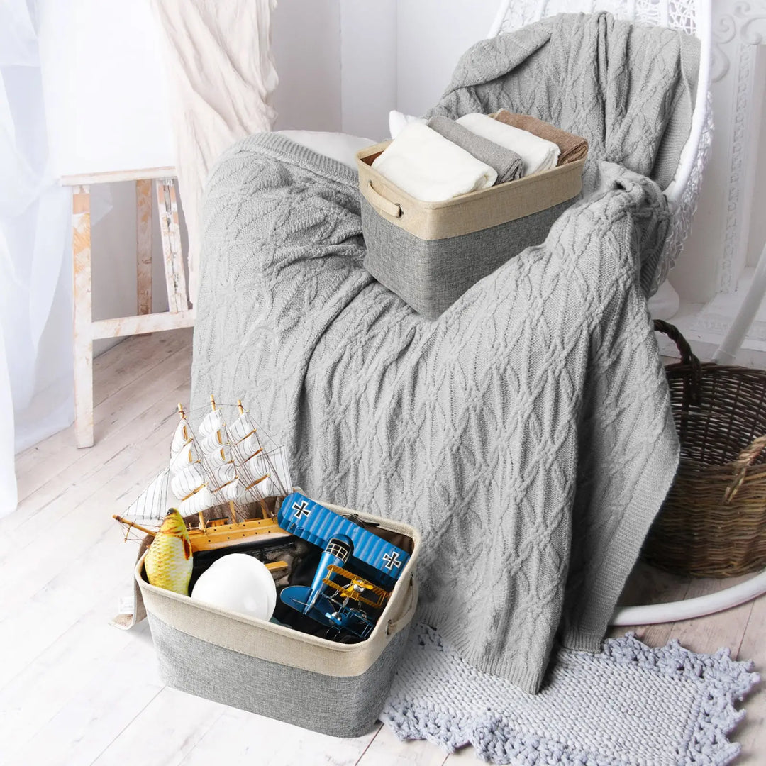 Gray linen storage bin with open top, holding pet toys and bedding