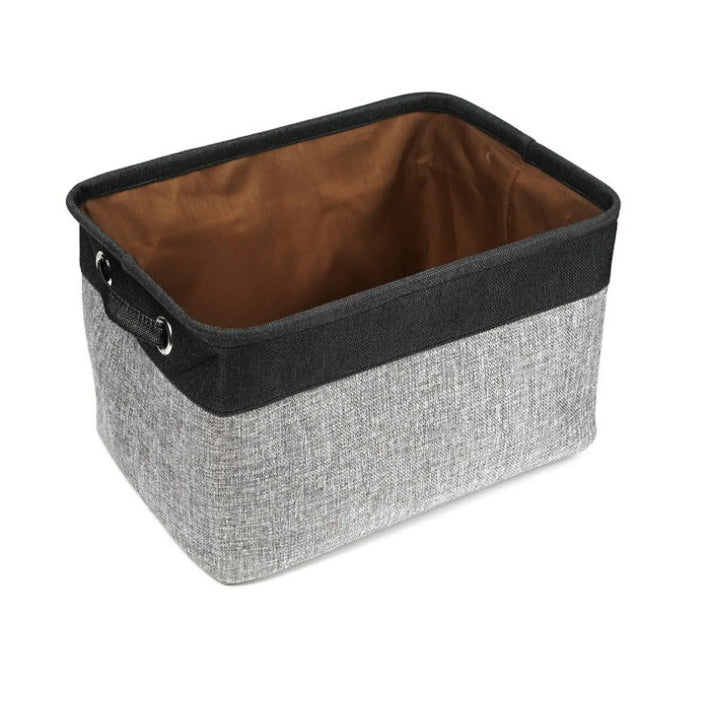 Dark gray linen storage bin with black trim and metal ring handles for pet supplies