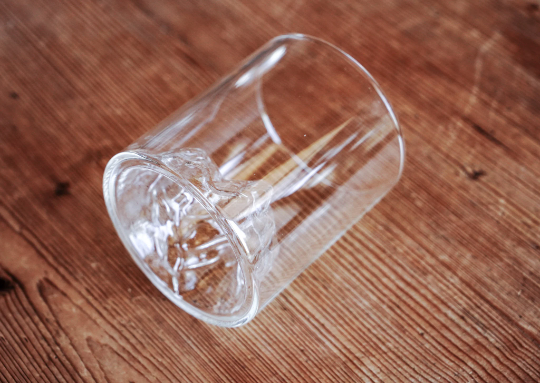 Clear glass whiskey tumbler with mountain range etched detail on the side