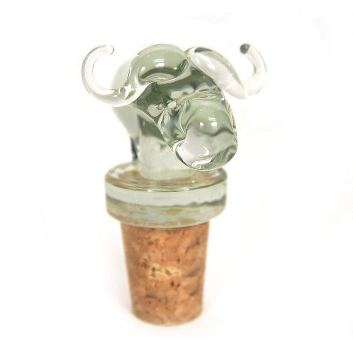 Animal-shaped glass wine stopper with green-tinted clear figure and brown cork, close-up