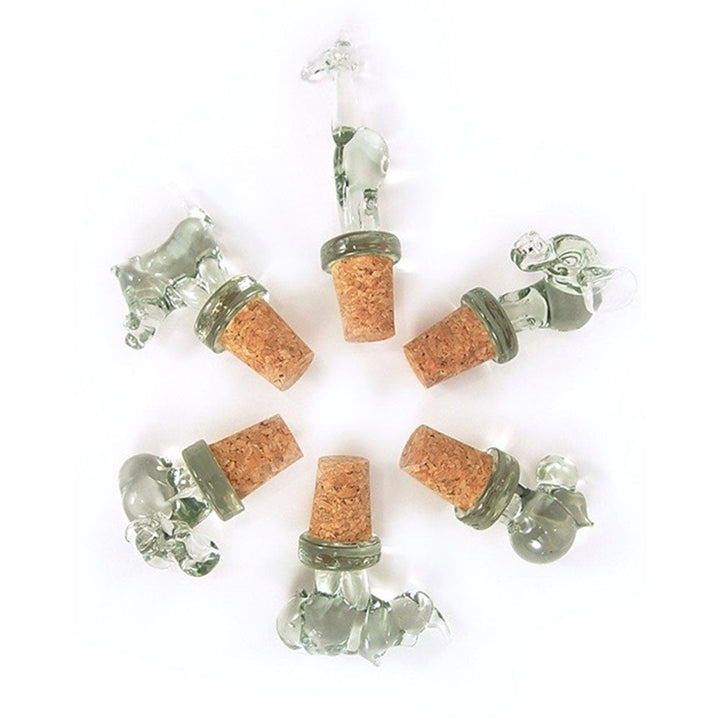 Assorted animal-shaped glass wine stoppers with clear figures and brown corks, set view