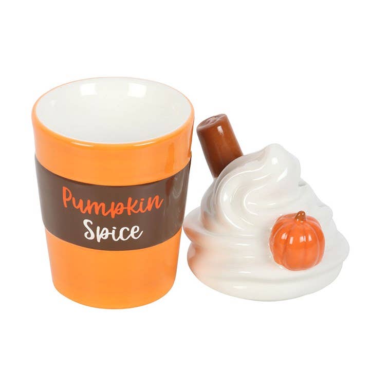 Orange and brown lidded wax warmer with white lid shaped like a whipped topping