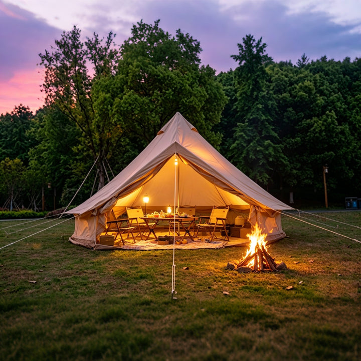 Bell tent with open entrance and warm lights, fire pit burning in front