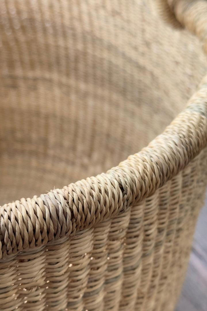 Close-up of natural woven basket weave with braided rope handle edge