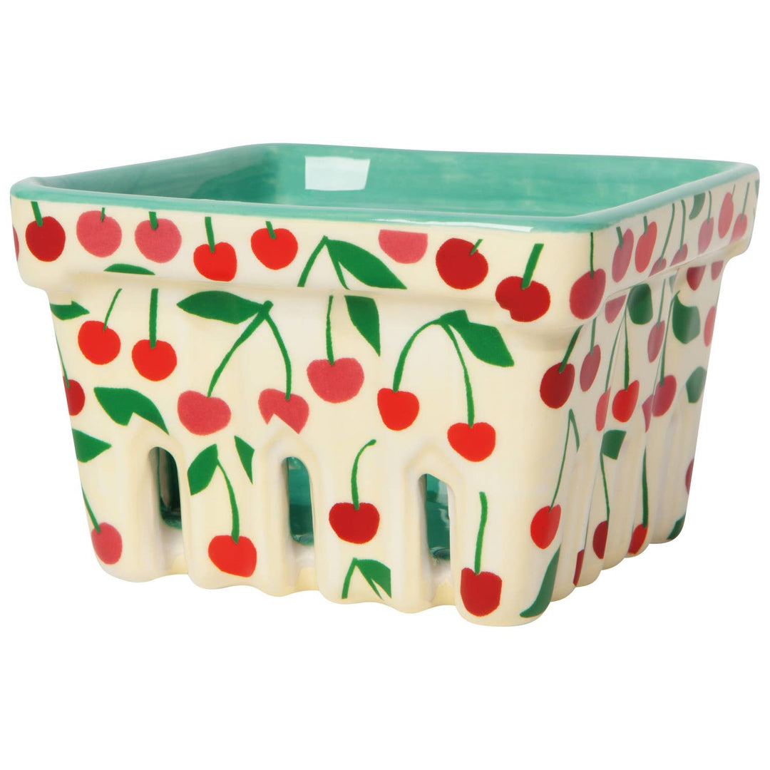 Cherry-pattern storage basket with green rim and scalloped sides