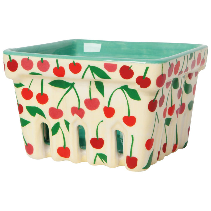 Cherry-pattern storage basket with green rim and scalloped sides